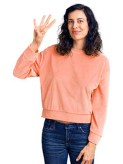 Young beautiful hispanic woman wearing casual clothes showing and pointing up with fingers number four while smiling confident and happy.