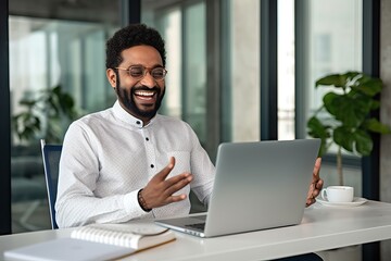 Happy business man hr manager having hybrid virtual interview meeting, talking to client consulting customer communicating online on conference call working on laptop computer in office.
