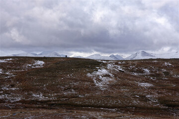 Two people walking in mountains of Scottish Highlands