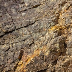 Granite background for design. Rough cracked mountain surface