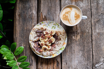 Homemade flatbread with chocolate and bananas on a wooden background.
