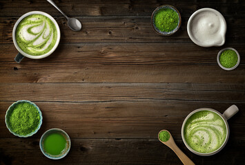 Matcha latte and green tea powder ingredients on dark wood background with copy space