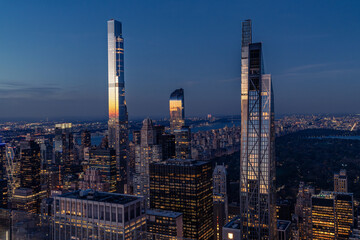 Fototapeta premium Aerial city skyline at night with last sun reflections