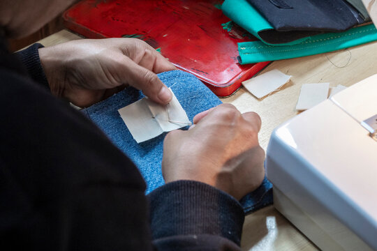 Close-up of Hand Sewing on a Blue Fabric