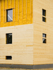 Facade cladding works with wooden planks after facade spraying with thermal insulation foam - obrazy, fototapety, plakaty