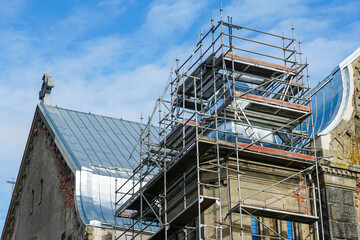 Tin roofing replacement of an old Lutheran stone church using complicated scaffolding