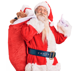 Old senior man with grey hair and long beard wearing santa claus costume holding bag with presents surprised with an idea or question pointing finger with happy face, number one