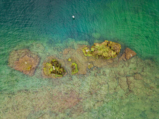 Aerial drone photo of small islands on a clear blue lake.