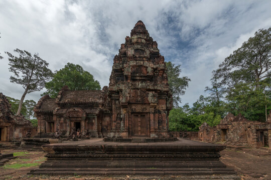 Ancient temple ruins under a cloudy sky in Cambodia