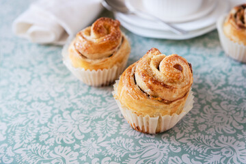 Puff pastry cupcakes - cruffins on blue background