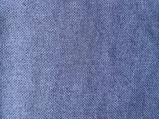 Close-up of textured denim fabric, showcasing the detailed weave pattern in classic blue, suitable for fashion and textile backgrounds