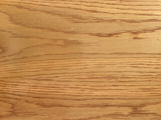 .Warm oak wood texture with natural grain patterns, ideal for a polished wooden surface background...