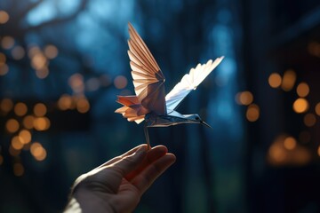 A person holding a paper bird in their hand. This image can be used to represent creativity, imagination, origami, or a message being delivered