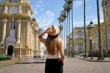 Visting Porto Alegre in Brazil. Rear view of young traveler woman in the historic center of Porto...