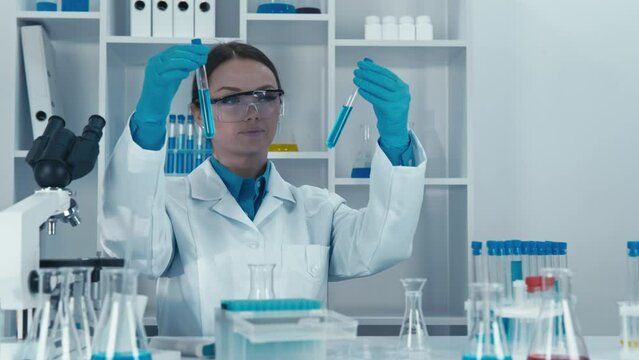 Scientists test infectious samples to determine their structure and the effectiveness of potential drugs in a pharmaceutical chemistry laboratory