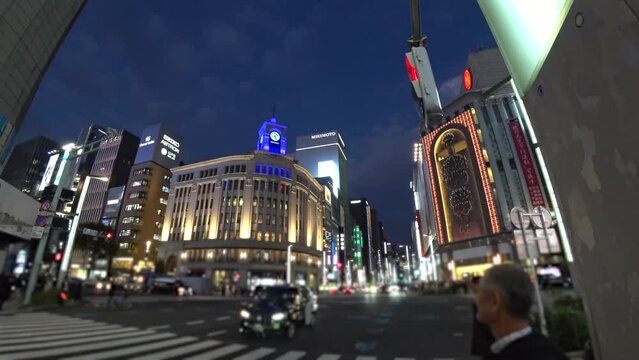 GINZA, TOKYO, JAPAN - NOV 2023 : Sunset to night, time lapse shot of Ginza area. Upmarket shopping and entertainment district, featuring numerous department stores, restaurants, night clubs and cafes.