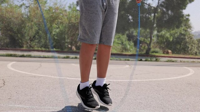 12 year old boy jumping rope at a park in Los Angeles. Slow Motion