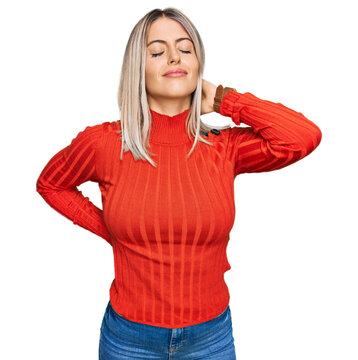 Beautiful blonde woman wearing casual clothes suffering of neck ache injury, touching neck with hand, muscular pain