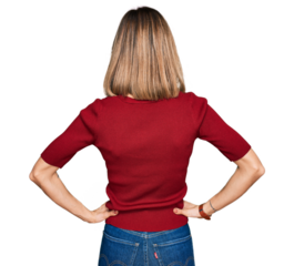 Young blonde girl wearing casual clothes standing backwards looking away with arms on body