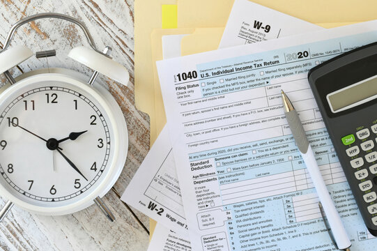 Filling out income tax form paperwork, filing taxes