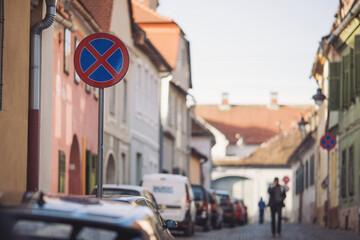 Road signs about evacuation and parking prohibition in old european town, traffic. No parking Sign...