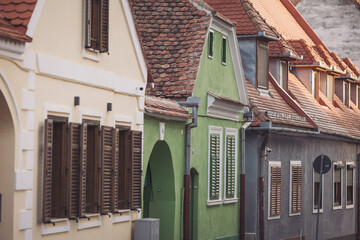 Beautiful streets of the Romanian city of Sibiu, with colorful houses. Small houses in the city. Beautiful historic houses on the streets of the Old Town in Sibiu. Transylvania. Romania.