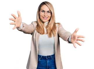 Young blonde woman wearing business shirt and glasses looking at the camera smiling with open arms for hug. cheerful expression embracing happiness.