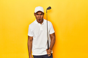African American man golfer, yellow studio backdrop, screaming very angry and aggressive.