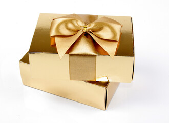 golden gift box with ribbon isolated on white