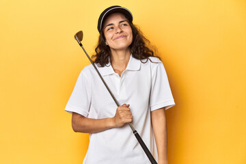 Golfer woman with cap, golf polo, yellow studio, dreaming of achieving goals and purposes