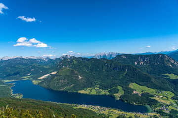 Stunning aerial panorama view of Grundlsee lake from Trisselwand with peaks of Styrian Alps in background on a sunny summer day, Styria, Austria - 688833372