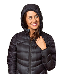 Middle-aged woman in black down coat in studio