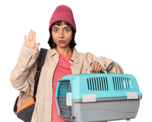 Young Hispanic woman ready for travel with pet carrier smiling and raising thumb up