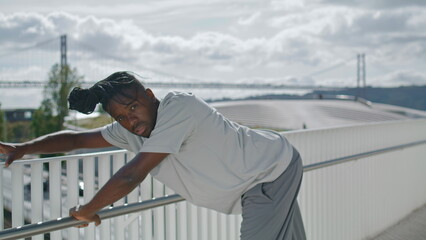 Acrobatic performer rehearsing dance at sea background. Talented man dancing