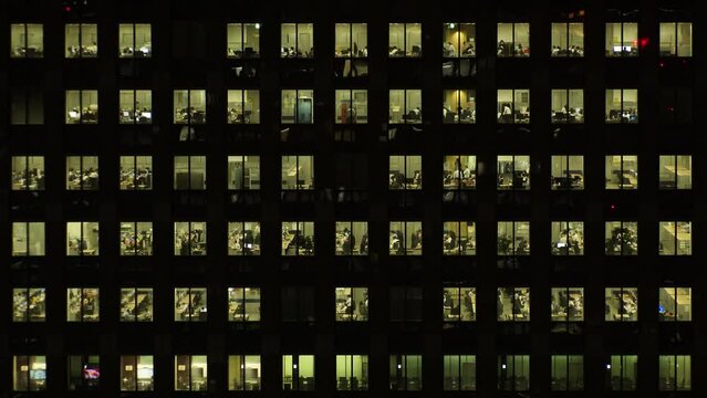 TOKYO, JAPAN : Close up shot of exterior of office building window at night. Company, corporate, job, work and business people concept video. Time lapse shot. 