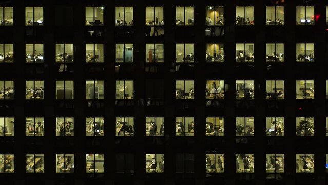 TOKYO, JAPAN : Close up shot of exterior of office building window at night. Company, corporate, job, work and business people concept video. Time lapse shot. 