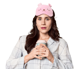 Young Caucasian in pajamas with to-go coffee in studio