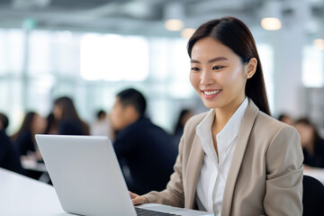 Fototapeta na wymiar Young attractive Asian woman working at the office with laptop