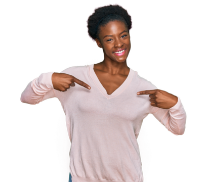 Young african american girl wearing casual clothes looking confident with smile on face, pointing oneself with fingers proud and happy.