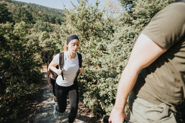 Active friends hike in nature, enjoying fresh air and conversation among trees and green landscape. Ideal for weekend adventurers, sporty tourists or anyone who loves the outdoors.