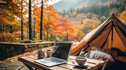outdoor desktop business office beside camping tent on summer holiday.	