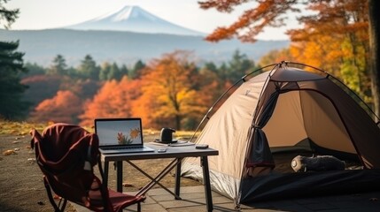outdoor office near camping tent at Mount Fuji of businessman while traveling on holiday.