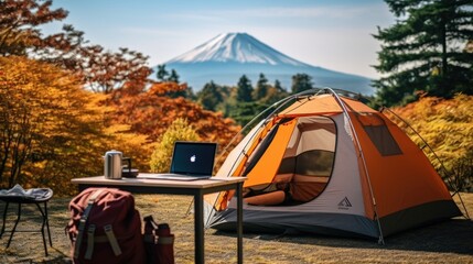 outdoor office near camping tent at Mount Fuji of businessman while traveling on holiday.