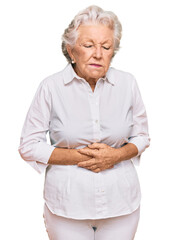 Senior grey-haired woman wearing casual clothes with hand on stomach because nausea, painful disease feeling unwell. ache concept.