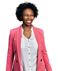 African american woman with afro hair wearing business jacket winking looking at the camera with...