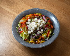 top view vegetable bowl with feta cheese, on wooden table