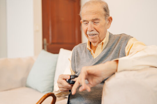 Older man use fingertip pulse oximeter check blood oxygen pressure