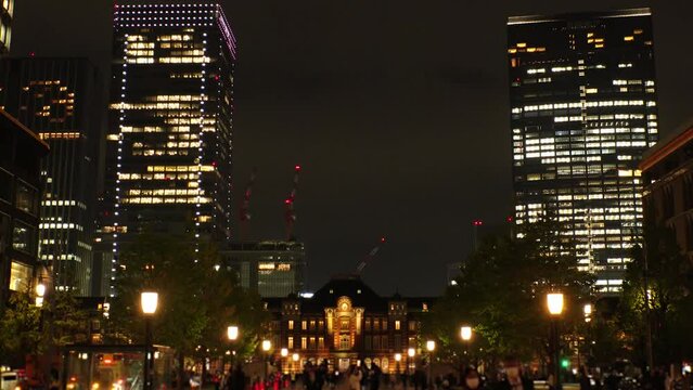 TOKYO, JAPAN - NOVEMBER 2023 : View of buildings around TOKYO STATION at night. Time lapse shot.