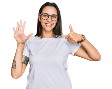 Young hispanic woman wearing casual white t shirt showing and pointing up with fingers number six while smiling confident and happy.