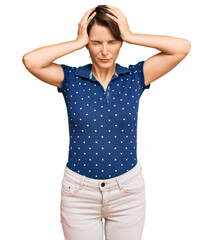 Fototapeta premium Young brunette woman with short hair wearing casual clothes suffering from headache desperate and stressed because pain and migraine. hands on head.